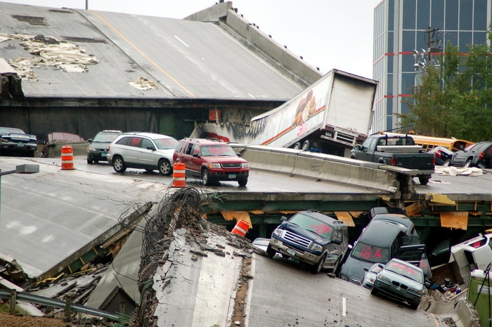 Cars rest on the collapsed portion of I-35W Mississippi River bridge, after August 1st, 2007 collapse